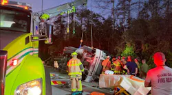 Fire crews work to extricate a heavily trapped cement truck driver.