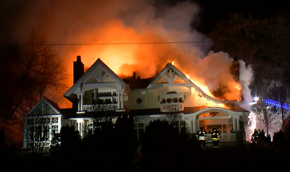 Firefighters use and aerial ladder to control fire in a 6,300 square foot home on Dec. 27, 2021.