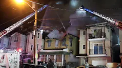 Firefighters use aerial devices to extinguish fire that damaged three Newark homes.