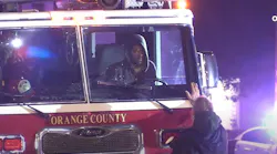 A citizen encourages the driver of a stolen fire truck to give up.