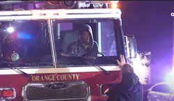 A citizen encourages the driver of a stolen fire truck to give up.