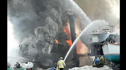 Firefighters use handlines, marine and aerial streams to control fire involving two large vessels.