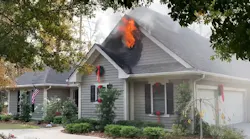 Fire vents out the gable end of the structure fire prior to firefighter arrival.