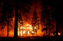 The Dixie fire burns a home in the Indian Falls area of Plumas County, CA, in July 2021.