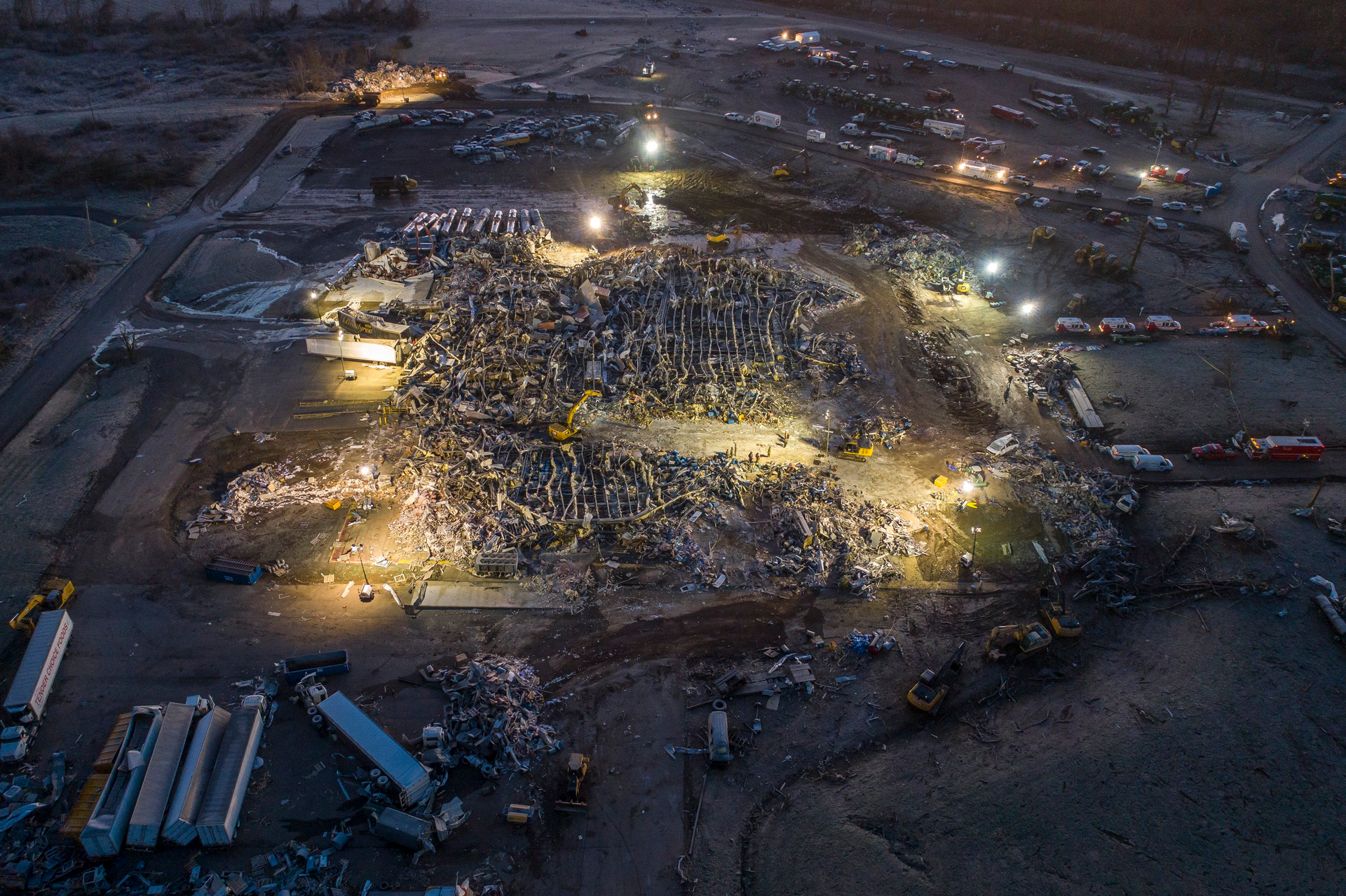 Rescue crews work at the Mayfield Consumer Products candle factory after a tornado traveled through the region Friday night.