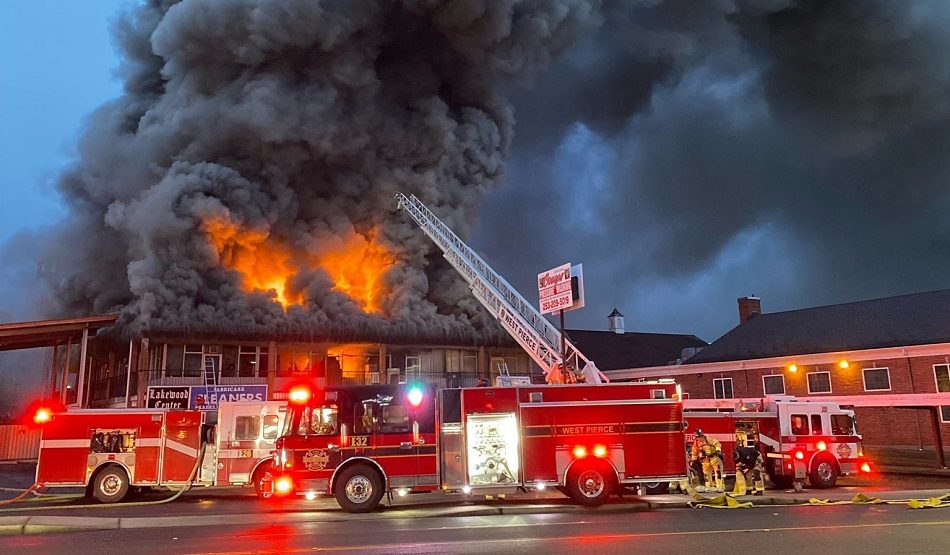 Firefighters battle heavy fire through the roof at a Lakewood commercial building fire.