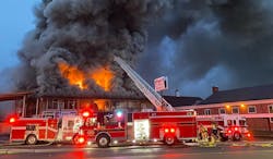 Firefighters battle heavy fire through the roof at a Lakewood commercial building fire. Firefighters battle heavy fire through the roof at a Lakewood commercial building fire.