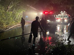 Neighbors pitched in to help firefighters on the remote island where lighting was limited, slowing access.