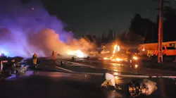 Firefighters work to extinguish the flames after an aircraft crash in El Cajon.