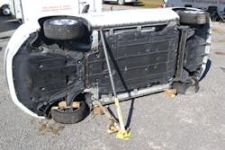 The cover over the floorpan-mounted battery of this side-resting Nissan LEAF EV is visible. Note how the stabilization strut isn’t in contact with the cover/battery but instead makes contact with the rocker channel. The cover over the floorpan-mounted battery of this side-resting Nissan LEAF EV is visible. Note how the stabilization strut isn’t in contact with the cover/battery but instead makes contact with the rocker channel.