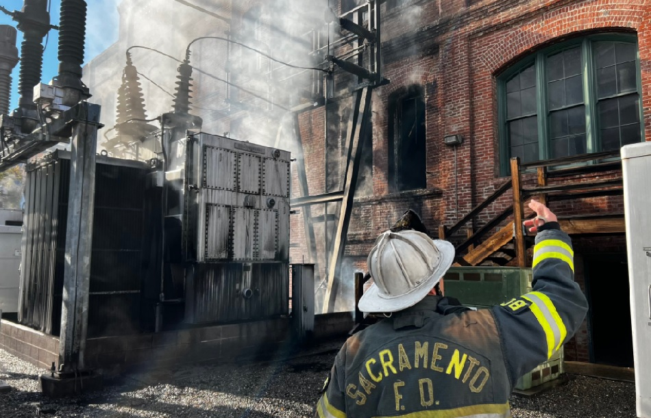 Officers survey the scene after fire damaged a substation and building in Sacramento.