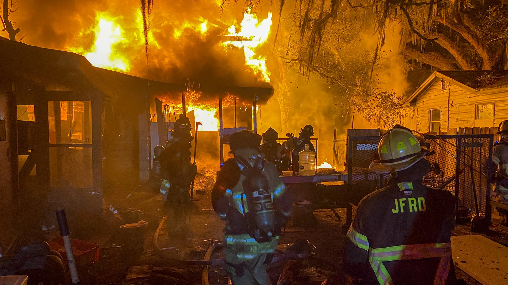 Fire engulfs a two-story home early Thursday that left two people dead and another injured.