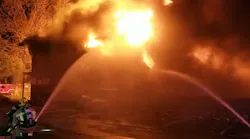 Dallas firefighters said heavy winds spread an apartment building fire to adjacent homes.