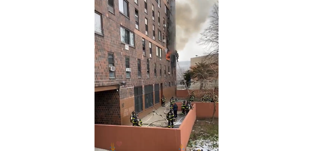 FDNY firefighters rescue person atop a portable ladder at a deadly Bronx apartment fire Sunday morning.