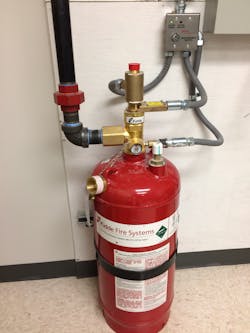 Figure 1. The source of the system is a high-pressure storage cylinder (seen here) that&rsquo;s piped to nozzles that discharge the agent.