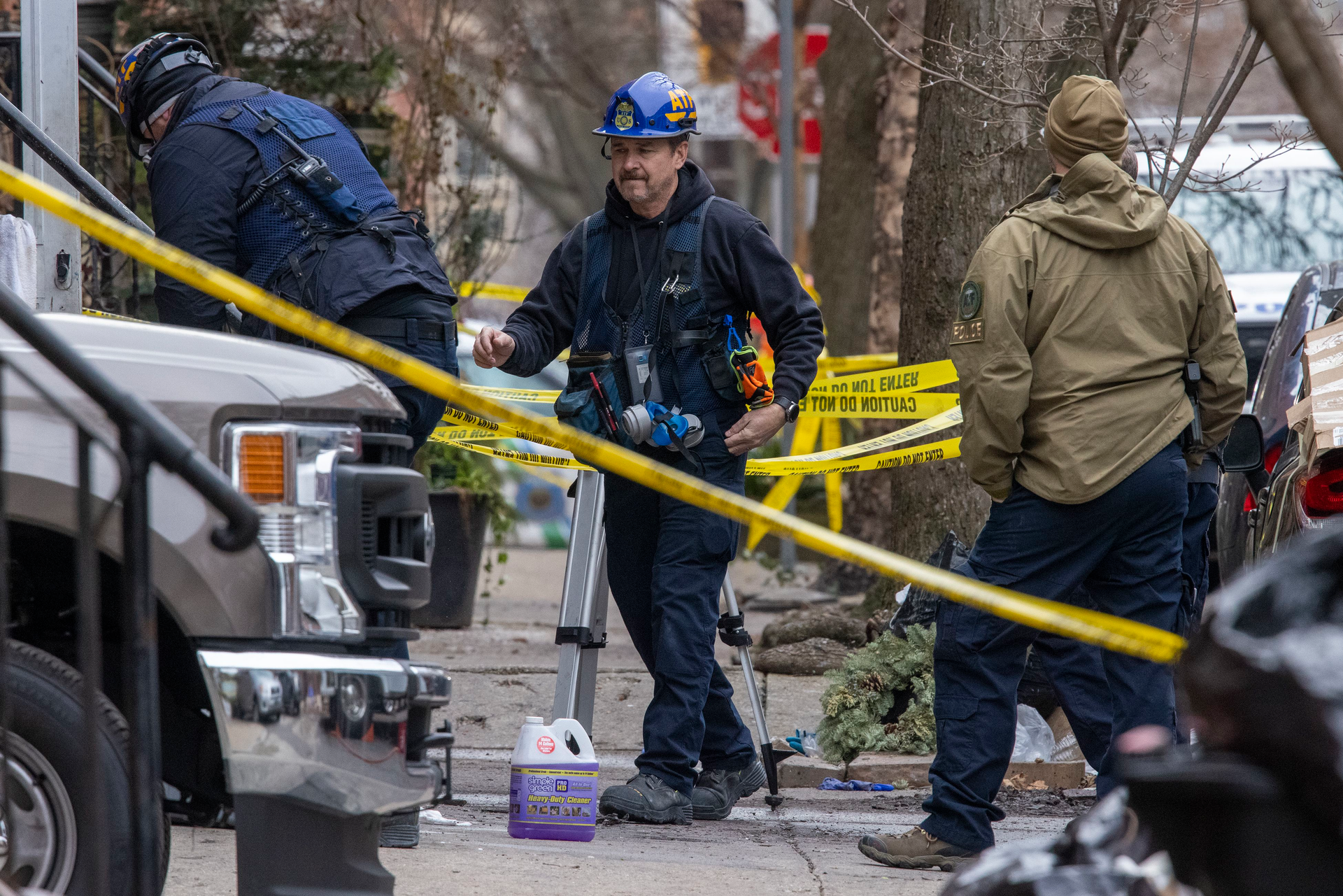 Philadelphia Fire Department fire marshals along with ATF officials investigate the remains of a rowhouse fire where 12 people died Wednesday.