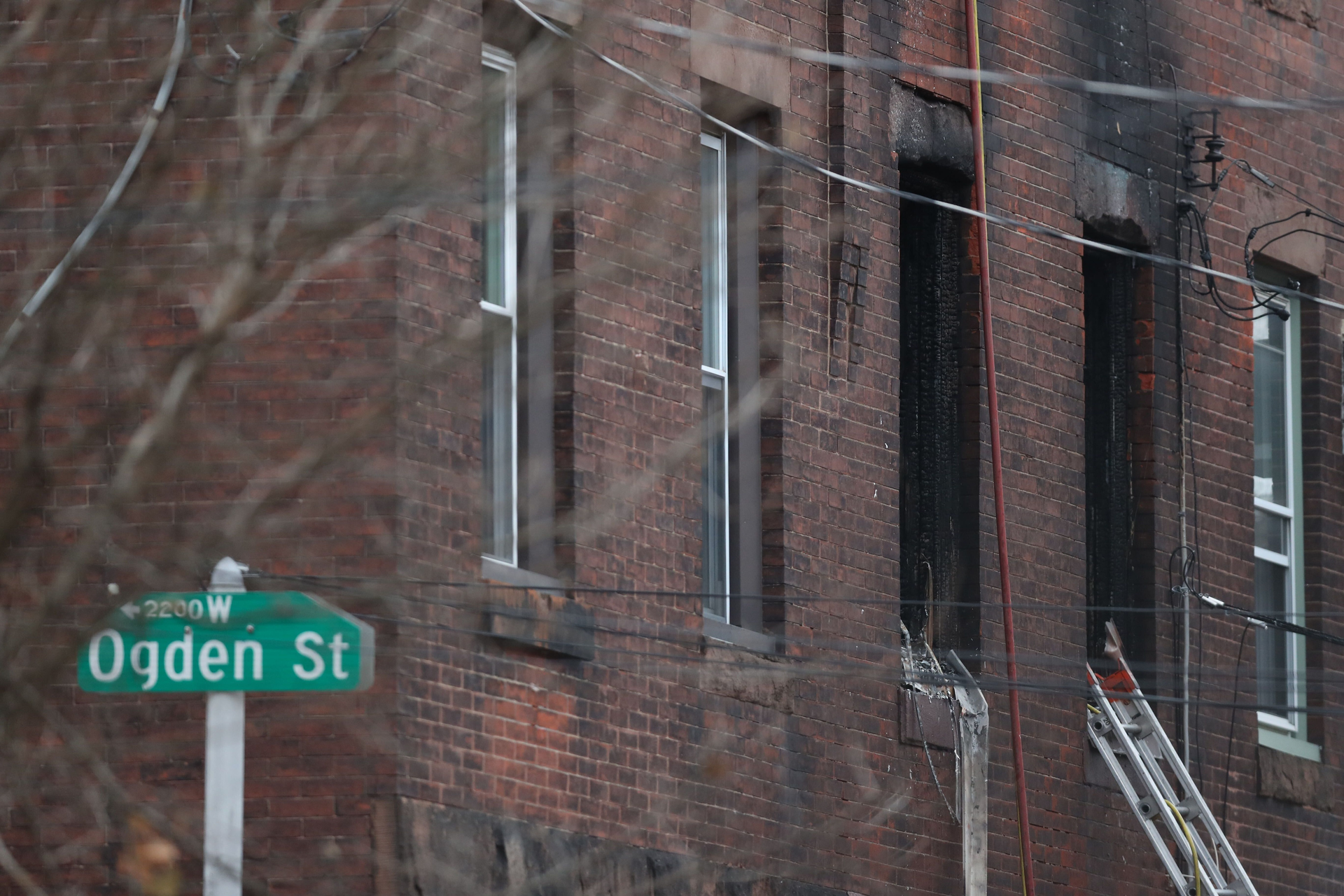 The charred windows of the rowhome on the 800 block of North 23rd Street in Philadelphia, where 12 people were killed.