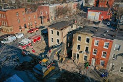 An excavator sits the remains of a vacant row house on Stricker Street as ATF investigators search for the cause of a fire that resulted in the death of three Baltimore City firefighters Monday morning. An excavator sits the remains of a vacant row house on Stricker Street as ATF investigators search for the cause of a fire that resulted in the death of three Baltimore City firefighters Monday morning.