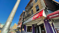 Investigators work at the scene where a Passaic firefighter rescued a woman from an apartment building at 896 Main Avenue on Wednesday.