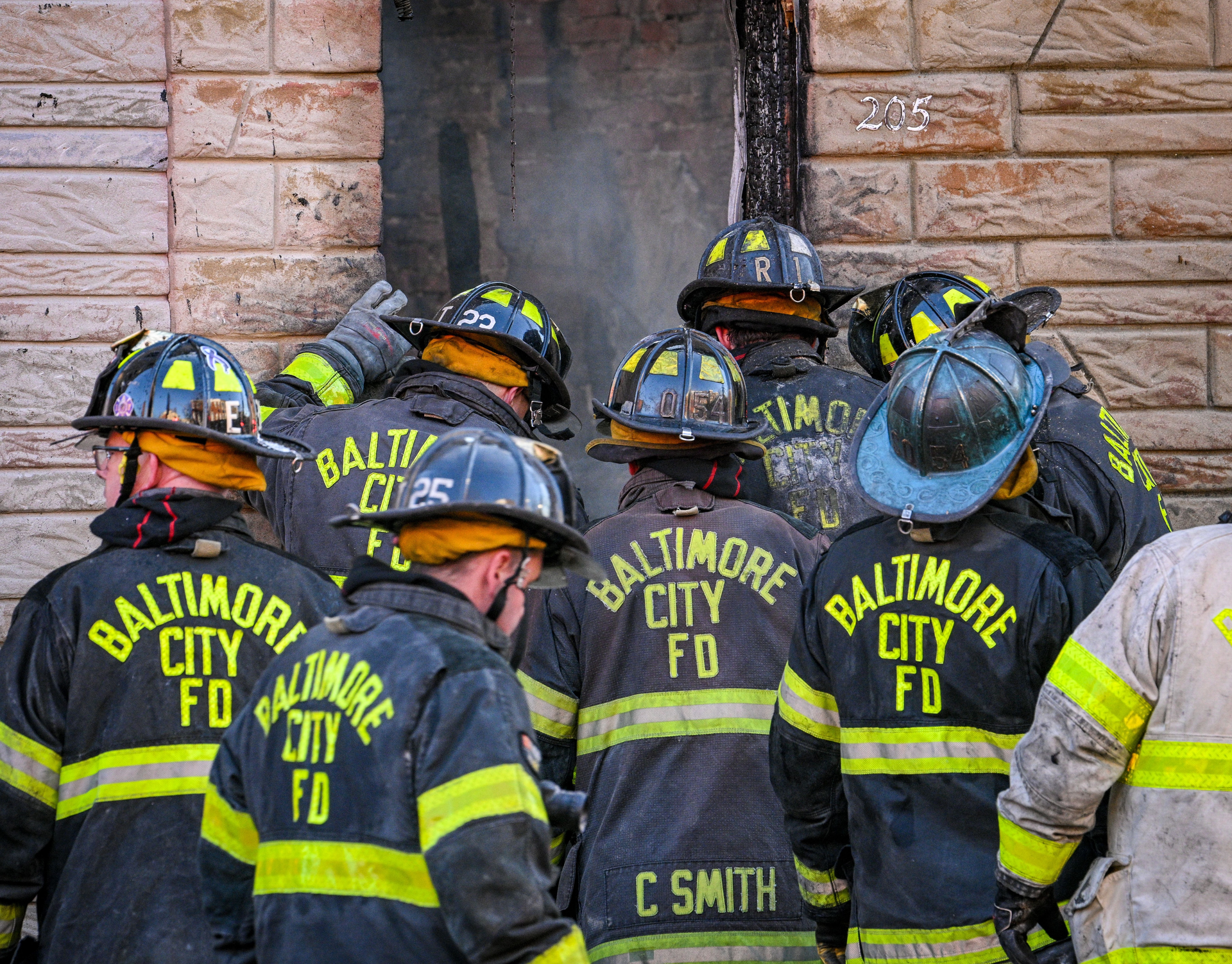 Baltimore City firefighters at the South Stricker Street rowhome fire scene Monday.