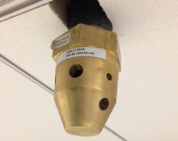 Figure 2. The source of the system is a high-pressure storage cylinder that’s piped to nozzles (seen here) that discharge the agent. Figure 2. The source of the system is a high-pressure storage cylinder that’s piped to nozzles (seen here) that discharge the agent.