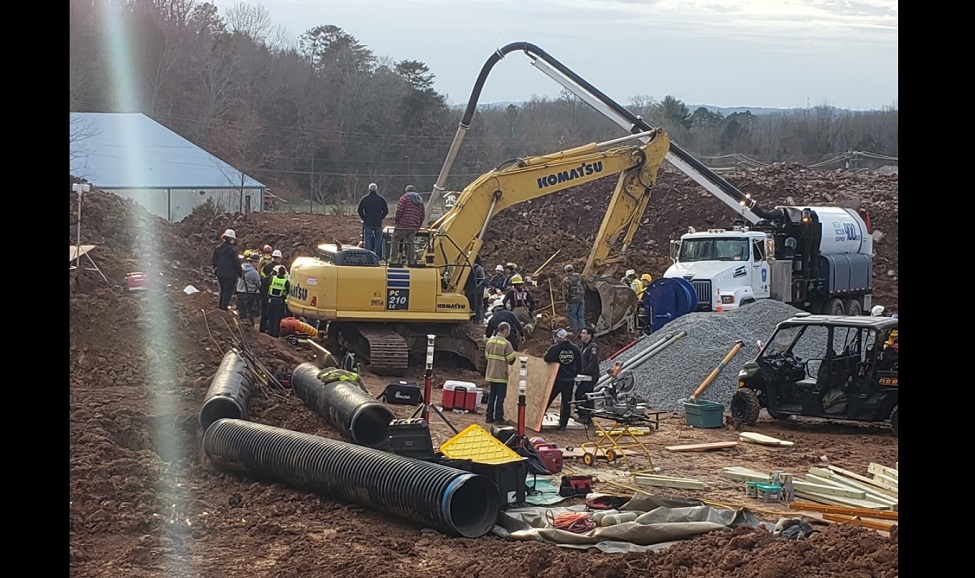 Firefighters from multiple agencies work for 8 hours to rescue two workers after a trenched collapsed on them.