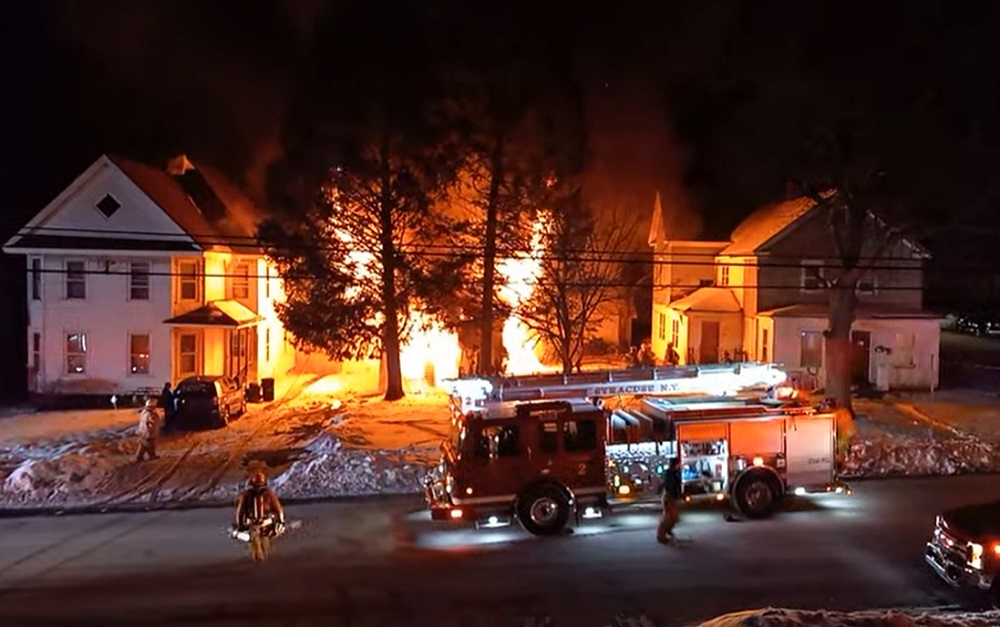 Syracuse firefighters battled a well involved dwelling fire that left three homeless.