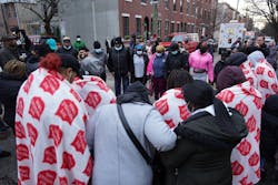 Family and friends pray together at the scene of a fatal fire in Philadelphia. Family and friends pray together at the scene of a fatal fire in Philadelphia.