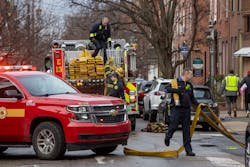 Philadelphia firefighters gather up equipment at the rowhome fire that claimed 13 lives on Jan. 5.