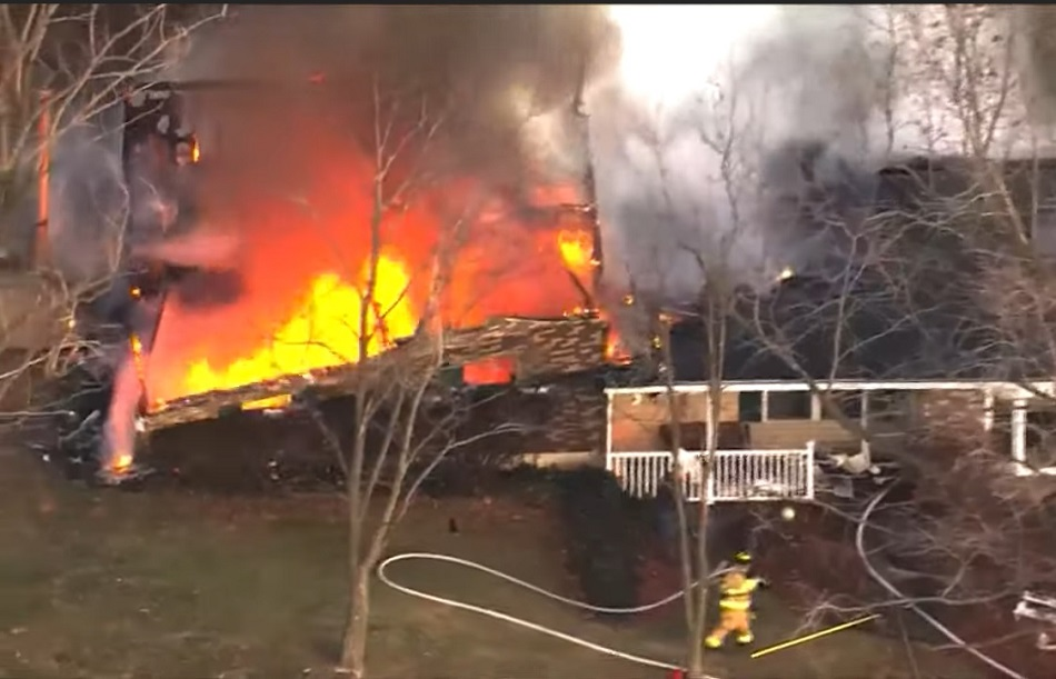 Winfield-Foley firefighters move moments before a stone veneer wall collapses while fighting a house fire.