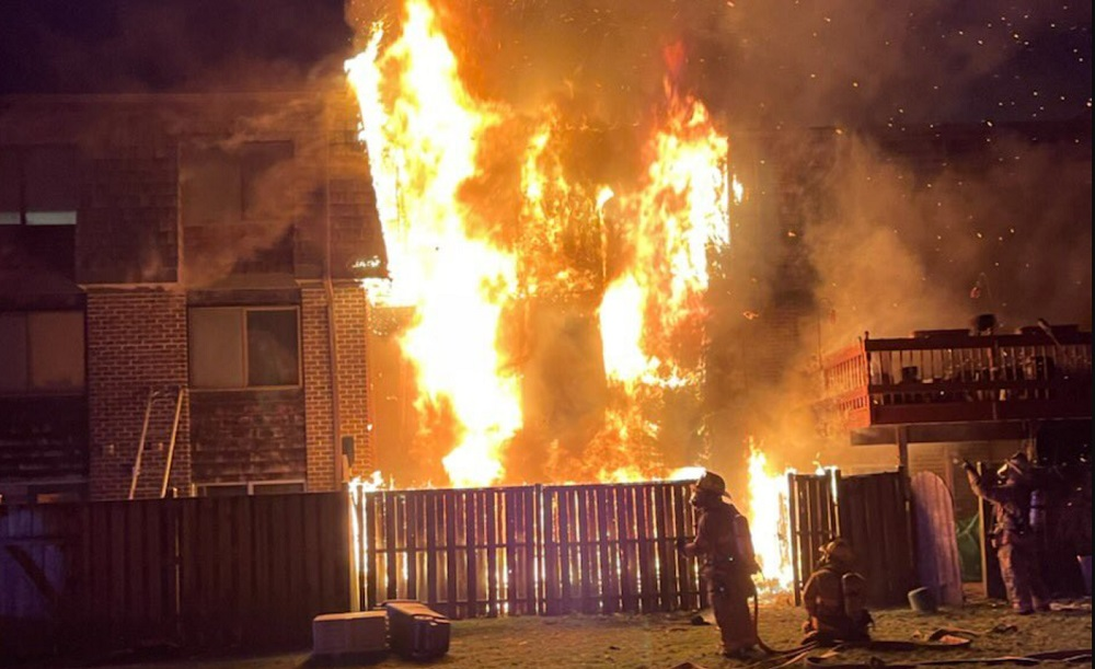 Montgomery County firefighters prepare to attack heavy fire at on overnight townhouse fire.