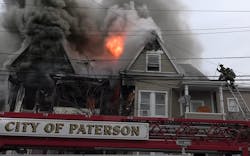 Paterson firefighters work to control heavy fire and smoke conditions during a residential fire. Paterson firefighters work to control heavy fire and smoke conditions during a residential fire.