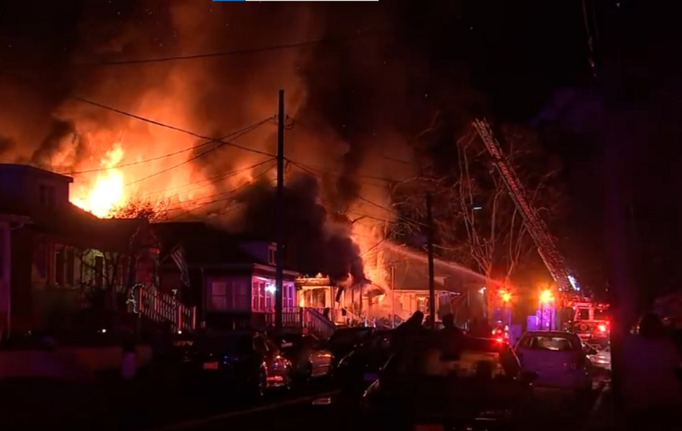 Firefighters battled heavy flames that destroyed a home and sent four occupants to the hospital in West Deptford.