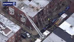 Firefighters work at the scene of a deadly rowhome fire in Philadelphia Wednesday morning.