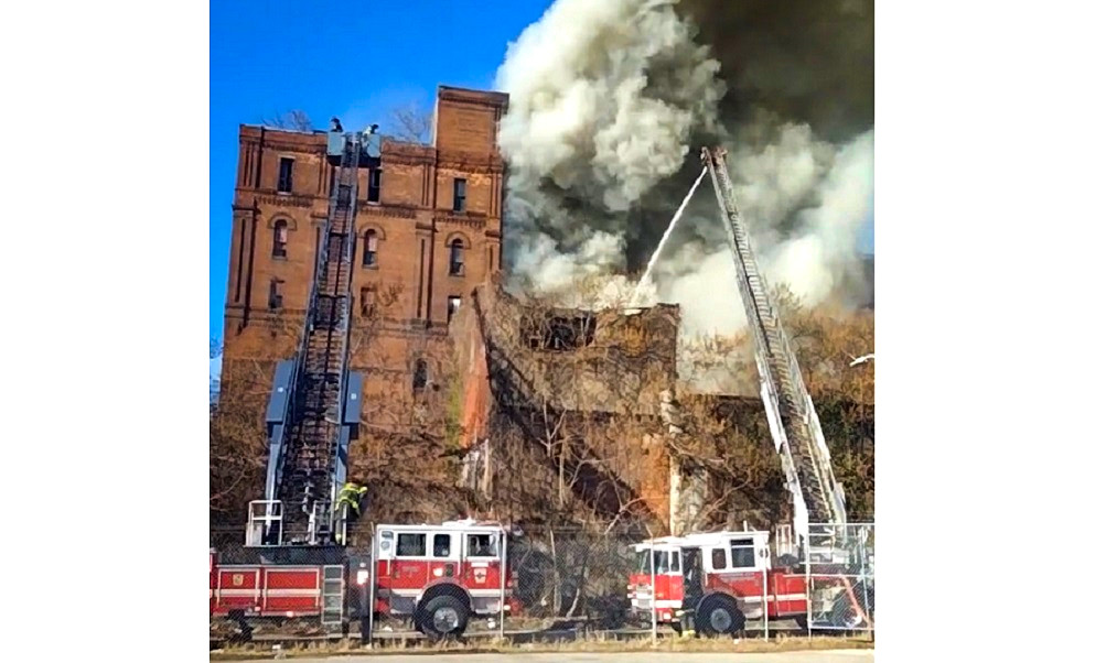 Baltimore firefighters battled a three-alarm fire in a 7-story vacant building that used to house a brewery.