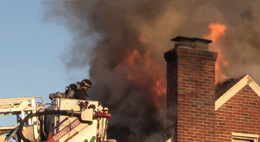 Firefighters from multiple departments battled fire in a two-story dwelling in Elizabethtown.