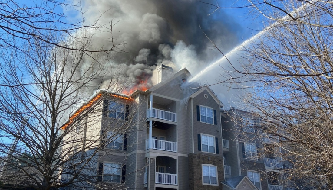 Firefighters use an aerial device to extinguish a fire in a Dekalb County apartment building.
