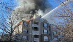 Firefighters use an aerial device to extinguish a fire in a Dekalb County apartment building.