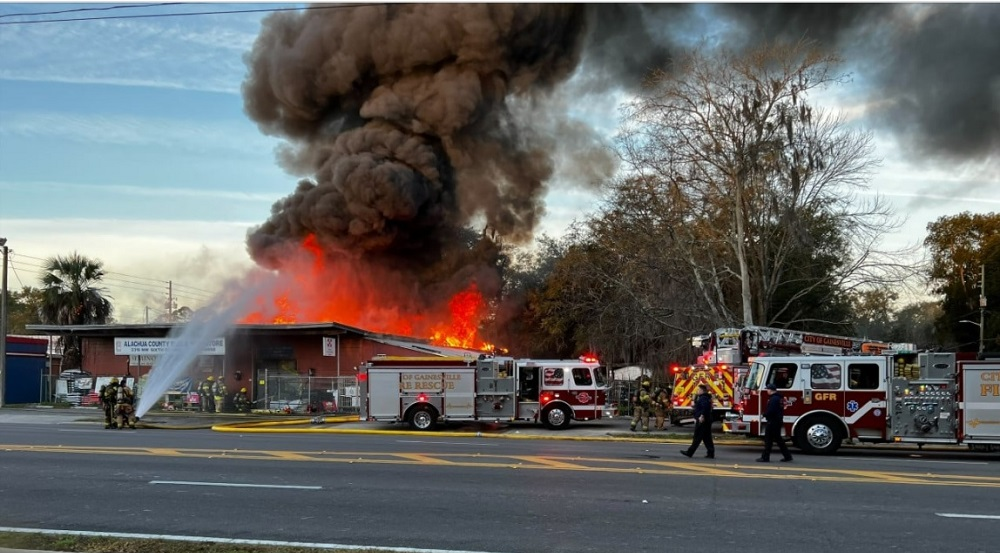 Gainesville firefighters work to control heavy flames at the Alachua County Feed & Seed Store.