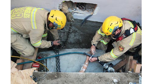 Los Angeles firefighters provide medical care while working to extricate a trench collapse victim.