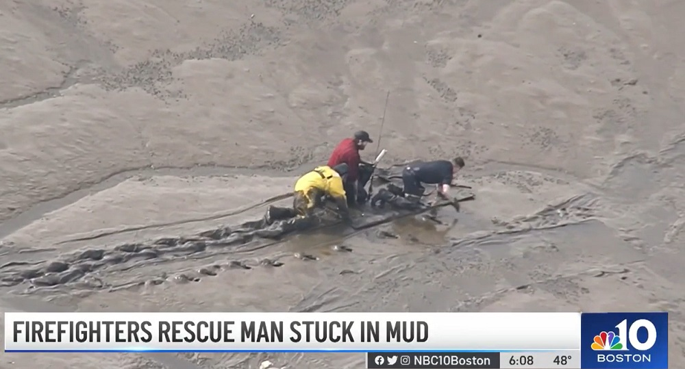 Salem firefighters rescue a fisherman stuck in the mud of the North River at low tide.