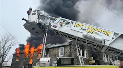 Firefighter work to control heavy fire in a auto shop in Ambler.