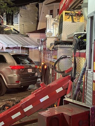 A firefighter who assists the chauffeur can be key to the quick and efficient positioning of the ladder apparatus, including for backing in to cover two sides of a structure.