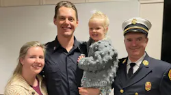 Firefighter Justin Haley, with his wife and daughter, along with West Newbury Fire Chief Michael Dwyer.