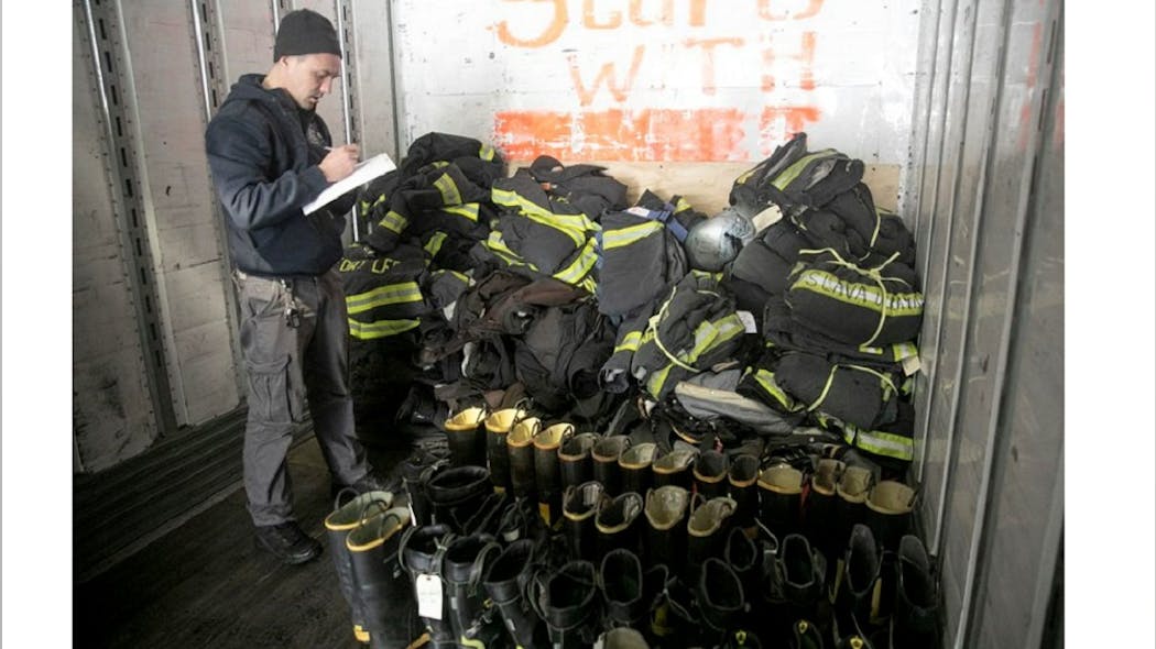 Clifton firefighter Oleg Skachko logs donated equipment in the back of a trailer on Wed. March 9, 2022. The Clifton Fire Department is collecting turnout gear from area departments to send to Ukraine.