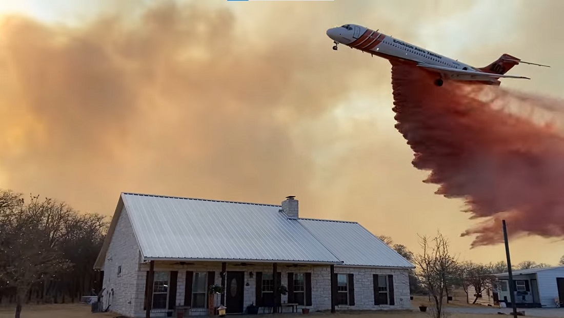 A large air tanker drops retardant to protect structures on the Walling Fire in Eastland County on March 16, 2022.