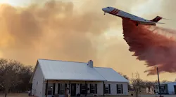 A large air tanker drops retardant to protect structures on the Walling Fire in Eastland County on March 16, 2022.