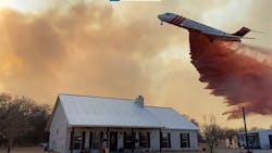 A large air tanker drops retardant to protect structures on the Walling Fire in Eastland County on March 16, 2022. A large air tanker drops retardant to protect structures on the Walling Fire in Eastland County on March 16, 2022.