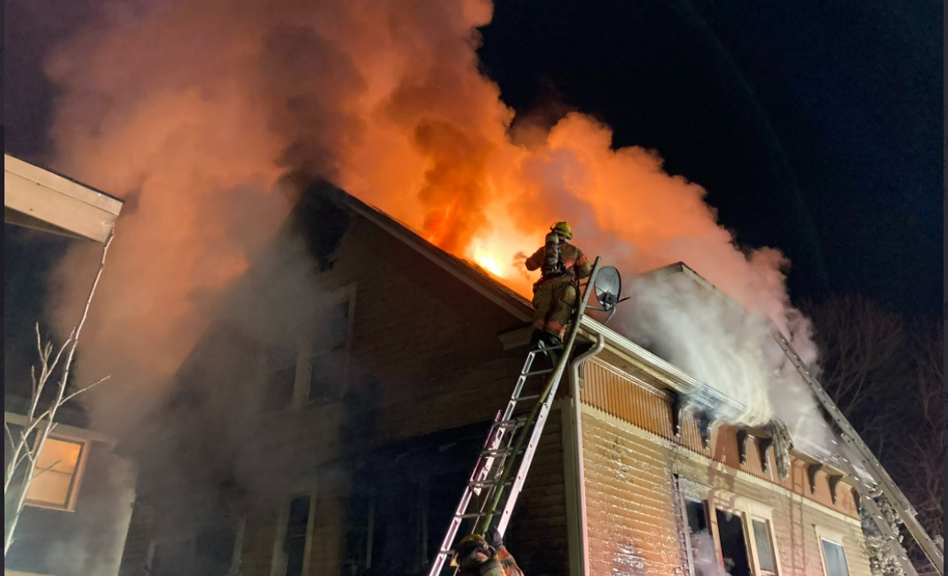 A Portland woman was hospitalized after firefighters rescued her from a two-alarm blaze.