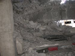 Construction materials in the debris of a pancake collapse create voids between floors.